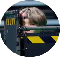 a man wearing a headband is peeking through a fence