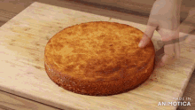 a person is cutting a cake on a wooden cutting board made in animotica