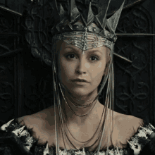 a woman with a crown on her head and a necklace around her neck