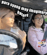 two women are sitting in a car with the words para syang may imaginary haters written above them .