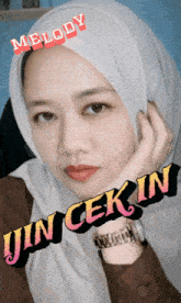 a woman wearing a hijab with melody jin cek in written on her face