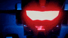 a close up of a red light that looks like a robot