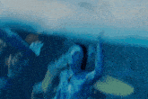 a blurry picture of a person in the water with their arms in the air