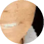 a close up of a person 's face in a circle with a blurred background .