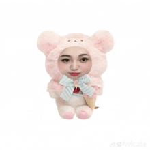 a stuffed animal wearing a pink teddy bear hat holding an ice cream cone