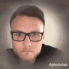 a man wearing glasses and a black shirt has #photolab written on the bottom right