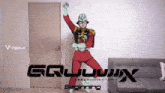 a man in a red suit is dancing in front of a sign that says " beginning " on it