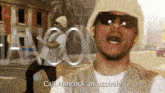 a man wearing sunglasses and a hat says call hancock an asshole in a video