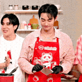 a man in a red apron with a panda on it