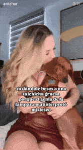 a woman in a red dress is kissing a brown dog on the cheek