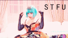 a woman with blue hair and black gloves is sitting on a couch with stfu written in the corner
