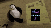 a penguin standing next to a piece of paper that says silver broke it