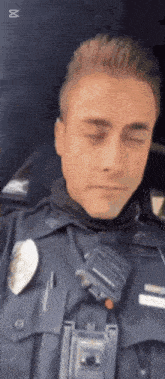 a police officer with his eyes closed and a walkie talkie on his chest