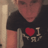 a person wearing a black shirt that says i heart rap on it