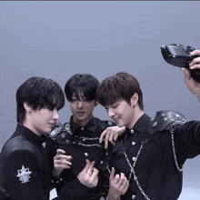 a man taking a selfie with two other men