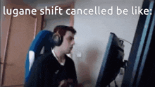 a man is sitting in front of a computer with headphones on .