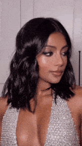 a woman with dark hair and a plunging neckline