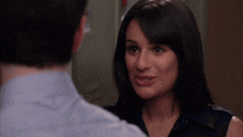 a man and woman are looking at each other and smiling