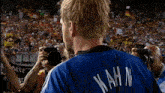a man in a kahn jersey is standing in front of a crowd