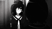 a black and white photo of a girl with glasses looking at herself in a mirror .