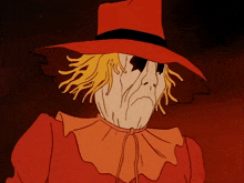 a scarecrow is wearing a red hat and orange collar