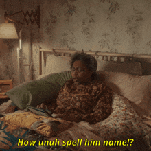 a woman laying in a bed with the words how unuh spell him name