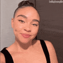 a woman with her hair in a bun is taking a selfie with the caption baileybassgifs