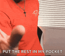 a man in a red t-shirt says " put the rest in my pocket "