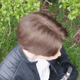a person wearing a leather jacket and a white shirt