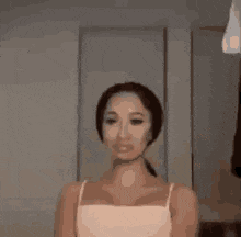 a woman is standing in front of a mirror in a room .