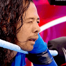 a close up of a wrestler 's face with the nextbigthing written on the bottom right
