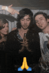 a group of people are posing for a picture with a praying hands emoji in the corner