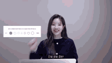 a woman in a blue sweater is smiling in front of a sign that says ' circles '
