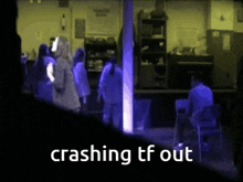 a group of people are standing in a dark room and the words crashing tf out are above them