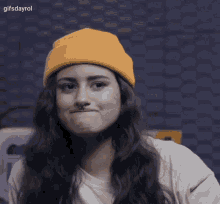 a woman wearing a yellow hat and a nose ring