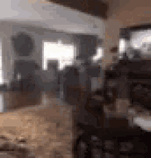 a blurry picture of a living room with a lot of furniture and a television .
