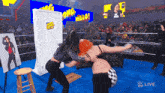 two women are wrestling in a wrestling ring with a sign that says welcome