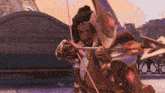 a man with a bow and arrow in front of a building