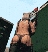 a woman in a bikini is standing in front of a sign that says ' coca cola '