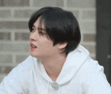 a close up of a person wearing a white hoodie