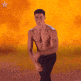 a shirtless man is dancing in front of an orange background with a star on it