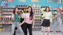 a group of young women are dancing in front of a sign that says snack and bread