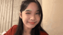 a close up of a girl making a funny face while sitting on a bed .