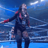 a woman is standing in a wrestling ring with the word smack on the ropes