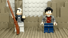 two lego figures are standing next to each other with one holding a wand