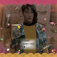 a man wearing a shirt that says rupert loves toby on it