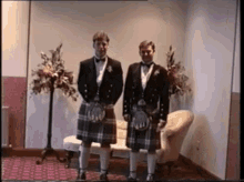 two men in kilts stand next to each other