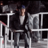 a man standing next to a railing holding a gun and a sign that says " i love you "