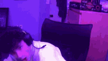 a man wearing headphones is sitting in a chair in a room .