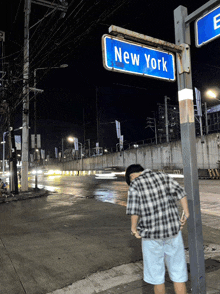 a street sign for new york is on a pole